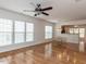 View of the living room featuring hardwood floors, white walls, and a ceiling fan at 207 Callum Pl, Cary, NC 27519