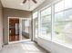This is a bright sunroom with large windows and a glass door that leads to the outside at 207 Callum Pl, Cary, NC 27519