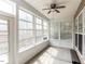 Inviting sunroom with large windows, a ceiling fan, and access to the outdoors at 207 Callum Pl, Cary, NC 27519