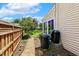 Landscaped backyard featuring lush garden beds, a stone path, a water collection system, and a wooden fence at 2128 Feather Ridge Dr, Holly Springs, NC 27540