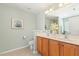 Bathroom featuring double sink vanity, tile flooring, and framed mirror at 2128 Feather Ridge Dr, Holly Springs, NC 27540