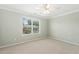 Carpeted bedroom features a ceiling fan and view of the outdoors through blinds at 2128 Feather Ridge Dr, Holly Springs, NC 27540