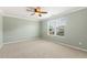 Carpeted bedroom with ceiling fan and view of the outdoors through the blinds at 2128 Feather Ridge Dr, Holly Springs, NC 27540