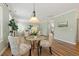 Charming dining area connects to the living room, featuring a stylish table and chairs at 2128 Feather Ridge Dr, Holly Springs, NC 27540