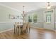 Bright dining area with hardwood floors, stylish chandelier, and large window at 2128 Feather Ridge Dr, Holly Springs, NC 27540