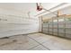 Spacious garage with overhead storage racks, concrete floor and automatic door opener at 2128 Feather Ridge Dr, Holly Springs, NC 27540