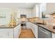 Well-lit kitchen equipped with stainless steel appliances, sleek countertops, and ample cabinet space at 2128 Feather Ridge Dr, Holly Springs, NC 27540