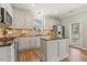 Kitchen features a center island, tile backsplash, and stainless steel appliances at 2128 Feather Ridge Dr, Holly Springs, NC 27540