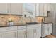 Stylish kitchen sink with granite countertops, stainless steel appliances, and ample storage at 2128 Feather Ridge Dr, Holly Springs, NC 27540