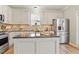 Well-equipped kitchen with a central island, stainless appliances, and ample counter space at 2128 Feather Ridge Dr, Holly Springs, NC 27540