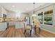 Eat-in kitchen with stainless steel appliances, white cabinets, and natural light at 2128 Feather Ridge Dr, Holly Springs, NC 27540