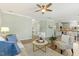Open-concept living room featuring hardwood floors, neutral decor, and seamless flow to kitchen at 2128 Feather Ridge Dr, Holly Springs, NC 27540