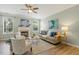 Cozy living room with a fireplace, hardwood floors, neutral tones, and ample natural light at 2128 Feather Ridge Dr, Holly Springs, NC 27540