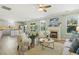 Open-concept living room with a fireplace and a view of the kitchen and dining area at 2128 Feather Ridge Dr, Holly Springs, NC 27540