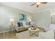 Cozy living room features neutral tones, a ceiling fan, and stylish decor at 2128 Feather Ridge Dr, Holly Springs, NC 27540