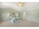 Main bedroom featuring vaulted ceiling, ceiling fan, and tranquil decor at 2128 Feather Ridge Dr, Holly Springs, NC 27540