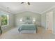 Spacious main bedroom featuring neutral carpet, ceiling fan, and vaulted ceiling at 2128 Feather Ridge Dr, Holly Springs, NC 27540