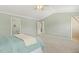 Main bedroom showcasing vaulted ceiling, ceiling fan, ensuite bathroom, and walk-in closet at 2128 Feather Ridge Dr, Holly Springs, NC 27540