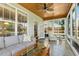 Cozy sunroom featuring an abundance of natural light and peaceful views of the lush surroundings at 2128 Feather Ridge Dr, Holly Springs, NC 27540