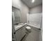 Full bathroom with a single vanity with sink and white cabinets and a shower and tub combo at 217 Busterfield Ct, Benson, NC 27504