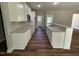 Modern kitchen featuring white cabinets, granite countertops, and stainless steel appliances at 217 Busterfield Ct, Benson, NC 27504
