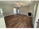 Open living room with modern fireplace, ceiling fan, and hardwood floors at 217 Busterfield Ct, Benson, NC 27504