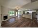 Open-concept living area with fireplace flows into a kitchen with white cabinets and granite countertops at 217 Busterfield Ct, Benson, NC 27504