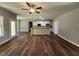 Bright living area with hardwood floors connects to a modern kitchen and a large window at 217 Busterfield Ct, Benson, NC 27504