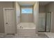 A soaking tub with a window view and separate glass shower enhance this bathroom's appeal at 217 Busterfield Ct, Benson, NC 27504