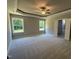 Spacious main bedroom with trey ceiling, neutral carpet, and natural light from the double windows at 217 Busterfield Ct, Benson, NC 27504