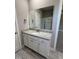 Bathroom vanity with drawers and cabinets and a framed rectangular mirror over a white sink at 217 Busterfield Ct, Benson, NC 27504