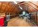 Large attic space with exposed beams and a window offering natural light, perfect for storage at 2417 Ridgeford Ct, Fuquay Varina, NC 27526