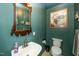 Charming bathroom with blue walls, decorative mirror, and classic fixtures at 2417 Ridgeford Ct, Fuquay Varina, NC 27526