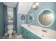 Bathroom featuring dual sinks, framed mirrors, and natural light from the window at 2417 Ridgeford Ct, Fuquay Varina, NC 27526