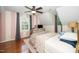 Bright bedroom features a ceiling fan, wood floors, and an abundance of natural light at 2417 Ridgeford Ct, Fuquay Varina, NC 27526