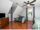 Bright bedroom featuring hardwood floors, sloped ceiling, and natural light from the windows at 2417 Ridgeford Ct, Fuquay Varina, NC 27526