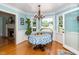 Cozy dining room featuring hardwood floors, wainscotting and large windows at 2417 Ridgeford Ct, Fuquay Varina, NC 27526