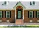Beautiful front entrance with flower boxes, a brick facade, and a well-maintained front yard at 2417 Ridgeford Ct, Fuquay Varina, NC 27526