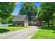 Brick house with black shutters, a well-manicured lawn, and a two-car garage for convenient parking at 2417 Ridgeford Ct, Fuquay Varina, NC 27526