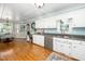 Traditional kitchen featuring white cabinets, stainless appliances, and hardwood floors at 2417 Ridgeford Ct, Fuquay Varina, NC 27526