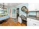 Bright kitchen area with white cabinets, granite countertops, and hardwood flooring at 2417 Ridgeford Ct, Fuquay Varina, NC 27526