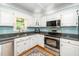 Traditional kitchen featuring white cabinets, stainless appliances, and granite countertops at 2417 Ridgeford Ct, Fuquay Varina, NC 27526