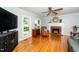 Bright living room with hardwood floors, a fireplace, and large windows offering plenty of natural light at 2417 Ridgeford Ct, Fuquay Varina, NC 27526