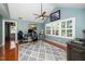 Spacious office with a high ceiling, fan, and ample natural light from large windows at 2417 Ridgeford Ct, Fuquay Varina, NC 27526