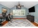 This home office has natural light, vaulted ceilings, a ceiling fan, and an accent wall at 2417 Ridgeford Ct, Fuquay Varina, NC 27526