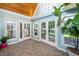 Well-lit sunroom with tile flooring, a wood paneled ceiling, and access to the outdoor living space at 2417 Ridgeford Ct, Fuquay Varina, NC 27526