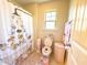 bathroom with corgi shower curtain, pink toilet seat, and tile floor at 2511 Kestrel Heights Ct Ct, Durham, NC 27703
