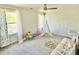 Bedroom with gray carpet, white walls, play area, and plenty of natural light at 2511 Kestrel Heights Ct Ct, Durham, NC 27703