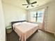 Bedroom with large window, ceiling fan, and gray bed frame with a pink quilt at 2511 Kestrel Heights Ct Ct, Durham, NC 27703
