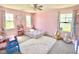 Pink bedroom featuring gray carpet, lots of light, stuffed animals, and toys at 2511 Kestrel Heights Ct Ct, Durham, NC 27703